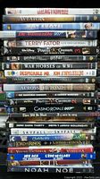 Stack of DVDs showing various movie titles from action, adventure, to animation and classics.