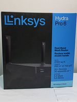 Front side of the LINKSYS Hydra Pro 6 retail box showing product branding, model, and key features like dual-band mesh, device capacity, and WiFi speed.