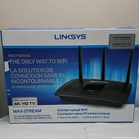 Front of the Linksys product box showing the router image, branding, and key features such as AC1750 MU-MIMO Gigabit, ideal for 4K/HD TV, dual band 1.7 Gbps speed.