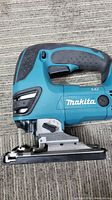 Side view of Makita LXT DJV180 cordless jigsaw showing ergonomic handle and trigger.