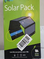 Front of box showing 'Solar Pack' with image of foldable solar panel and branding 'BigBlue 28W Solar Charger'.