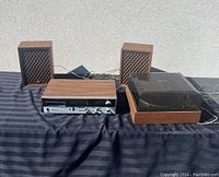 Full lot showing Webcor amplifier, pair of AGS speakers, and Garrard X10 record player arranged on black fabric against a wall.