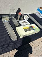 Overview of lot showing glass vases, metal trays, etched glass plates, crystal container, and boxed items including Wiesengrund set.