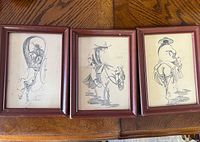 Three framed Chinese Western style drawings laid out on wooden surface.