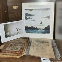 Overview photo showing the signed print, old geography book, and 1875 Canadian Teacher journal together.