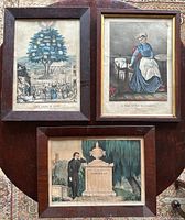 Three framed antique Currier & Ives prints laid out on a round wooden surface, showing full view of each print and frame.