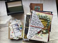 Assortment of cards, autograph book, and cue card filing box shown together