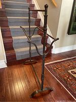 Angled front view of quilt rack showing two horizontal bars and spiral-fluted posts