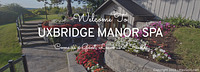 Exterior view showing Welcome to Uxbridge Manor Spa sign and landscaping