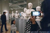 Interior gallery space at the museum showing classical busts and visitors.