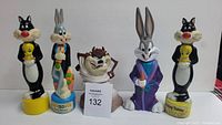 Five Soaky bubble bath bottles displayed in a row featuring Looney Tunes characters Taz, Bugs Bunny, Sylvester the Cat, and Tweety Bird. Some bottles may still contain bubble bath soap.