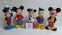 Front-facing photo of all 5 Soaky bubble bath bottles arranged side by side, featuring different Disney characters