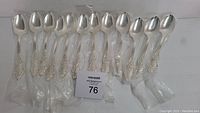 12 pieces of silver serving spoons in Renaissance pattern by 1847 Rogers Bros, individually wrapped.