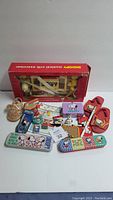 Overview of the complete Snoopy Peanuts collectibles lot including the musical crib exerciser box, figurines, pencils cases, mask, slippers and other small items.