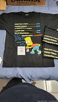 Front view of one black youth large T-shirt with colorful Bart Simpson El Barto graffiti print