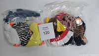 Two clear plastic bags containing a total of 10 vintage Ty Beanie Babies plush toys, including shark, zebra, swan, duck, and cardinal, visible with Ty tags and soft plush textures.