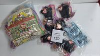 Photo showing several black bear figures from Ty Beanie Babies in plastic packaging and a bag with more Beanie Babies.