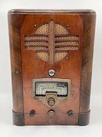 Front view of the Canadian General Electric wooden antique radio showing speaker grille, tuning dial with frequency bands, and control knobs.