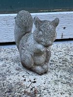 Front view of the concrete squirrel garden decoration showing the detailed texture and shape.
