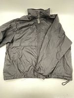 Full view of the black Eddie Bauer windbreaker jacket with zippered front and elastic cuffs