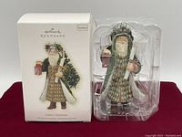 Father Christmas ornament in packaging with box showing front