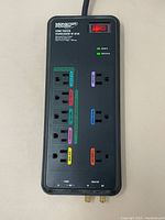 Top view of Monster Power Home Theatre Powercenter HT 810G showing multiple labeled power outlets and main power switch with indicator lights.