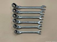 Set of 7 Imperial Mastercraft ratcheting combination wrenches with swivel box ends laid on a flat surface.