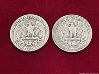 Two vintage US silver quarter dollars showing the reverse eagle side, against red background.