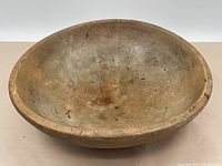 Top view showing interior of the wooden bowl with wear marks and dark spots.