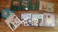 Photo of eleven nature-related books including animal kingdom, gardening, dinosaurs, and a fairy journal.