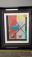Full view of the framed abstract artwork showing composition, colors, and framing.