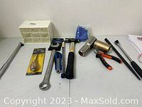 Wide photo showing all tools on table: wrench, hammer, metal clips, glue gun, two metal extensions, and white plastic box