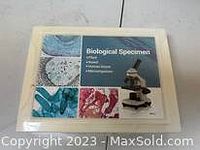 Closed box of biological specimen kit showing box art with microscope image and specimen images.