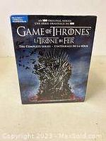 Front view of Game of Thrones Blu-ray complete series box set showing Iron Throne with icy spikes and flames, with blue Blu-ray label on top left corner.