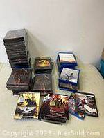 Overall lot of Blu-ray cases stacked and grouped, including standard and metalpak cases