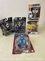 Lot of five boxed collectible figures including Masters of the Universe Skeletor and others.