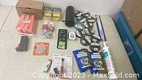 Full view of the contracting lot contents including adhesive packs, electrical tape, connectors, thermostat, caulking and hardware