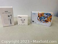Photo of the lot showing 98W USB-C power adapter, wireless earbuds box, and colorful Creative Pen Tablet box with cartoon artwork