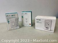 Three retail boxed smart home devices: TP-Link smart dimmer switch, TP-Link smart wall socket, BK-Link smart wall socket.