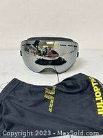 Front angled view of Julioptic ski goggles showing mirrored lens, black strap, and reflection details.