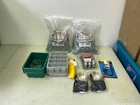 Photo of irrigation and garden accessories including bags of stakes, trays, garden tool, and wire spools.