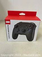 Front view of the retail box showing the black Pro Controller for Nintendo Switch with Nintendo branding and product name.