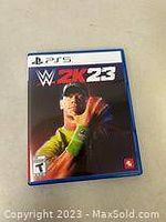 Front cover of WWE 2K23 game case for PS5 showing cover art