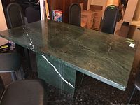Full view of green marble dining table top and chairs