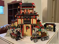 Front view of assembled fortress, dragon, vehicle and minifigures
