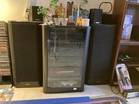 Overview of stereo cabinet with two floor speakers and two bookshelf speakers on top.