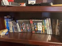 Shelf with video game cases and blank media boxes