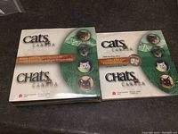 Two unopened original collector boxes for 1999 sterling silver fifty cent coins featuring cats from Royal Canadian Mint