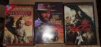 Three DVDs including Alexander Director's Cut, The Good, The Bad and The Ugly, and 300.