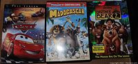 Three DVDs: Cars, Madagascar, Brother Bear 2
